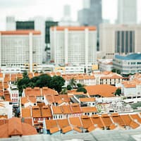 Roof Material for Long-Term Durability- tilt-shift photography of white-and-orange houses surrounded by high rise buildings at daytime