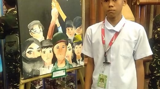 Arjen-poses-beside-his-painting-Pagbangon