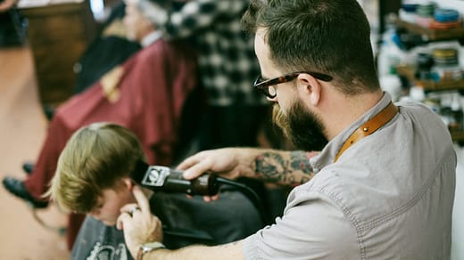 salon marketing ideas man shaving the boy's hair