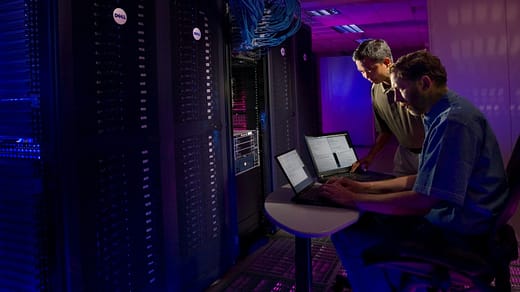 IT infrastructure woman in blue long sleeve shirt sitting on black chair