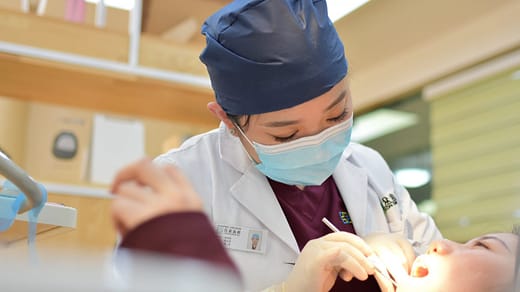 cosmetic dentistry woman doing dental on girl lying on bed