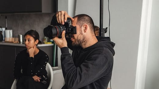 select the best photography studio man in black hoodie sitting on white plastic chair