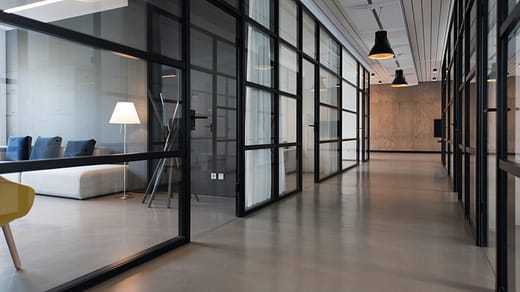 business office space hallway between glass-panel doors