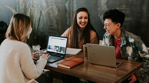 careers in education three people sitting in front of table laughing together