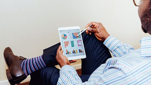 Financial Advisor person sitting on chair holding iPad