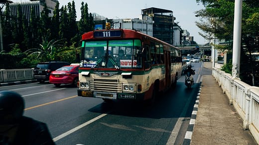 Trucking Authority red and white bus on road during daytime