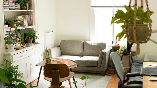 gray fabric loveseat near brown wooden table