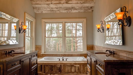 comfort room with white bathtub and brown wooden cabinets