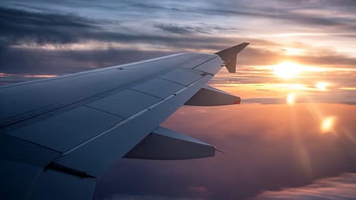 white airplane wing during sunset