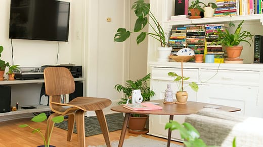 brown wooden table and chair beside bookshelf