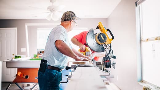 man standing infront of miter saw