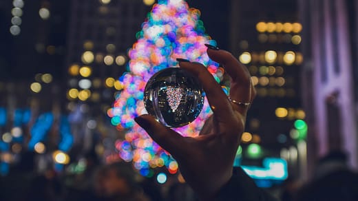 person holding clear glass ball