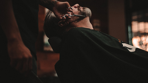 man sitting on barber's chair