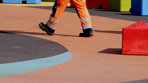 man in orange pants and black and white nike sneakers