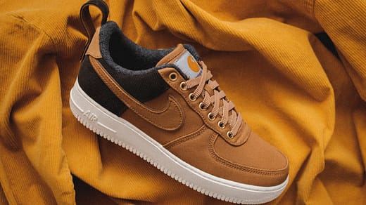 brown Nike sneaker on yellow textile