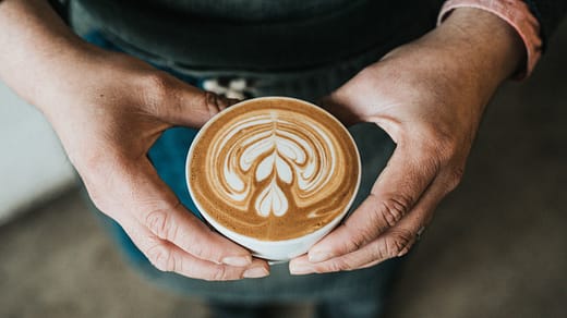 focus photography of coffee artwork