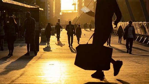 man walking on the field carrying bag