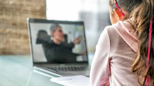 woman in pink long sleeve shirt sitting in front of macbook pro