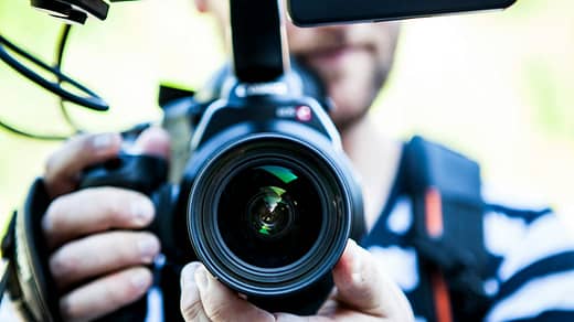 Person Holding Canon Dslr Camera Close-up Photo